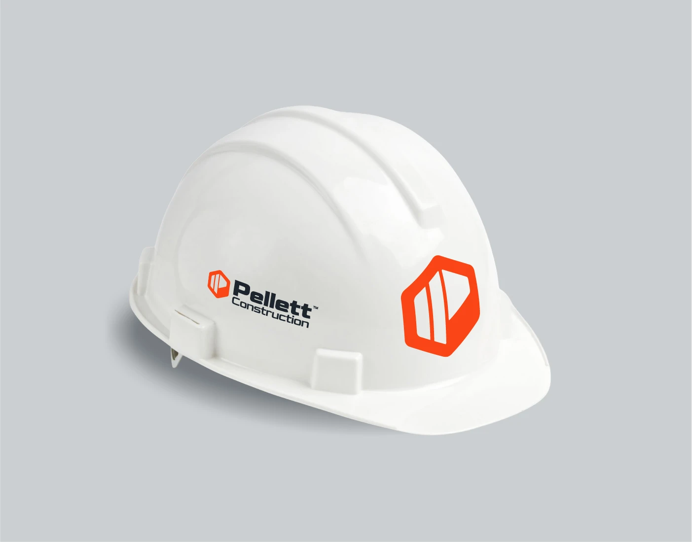Mockup of a white hard hat with the Pellett Construction mark and logo