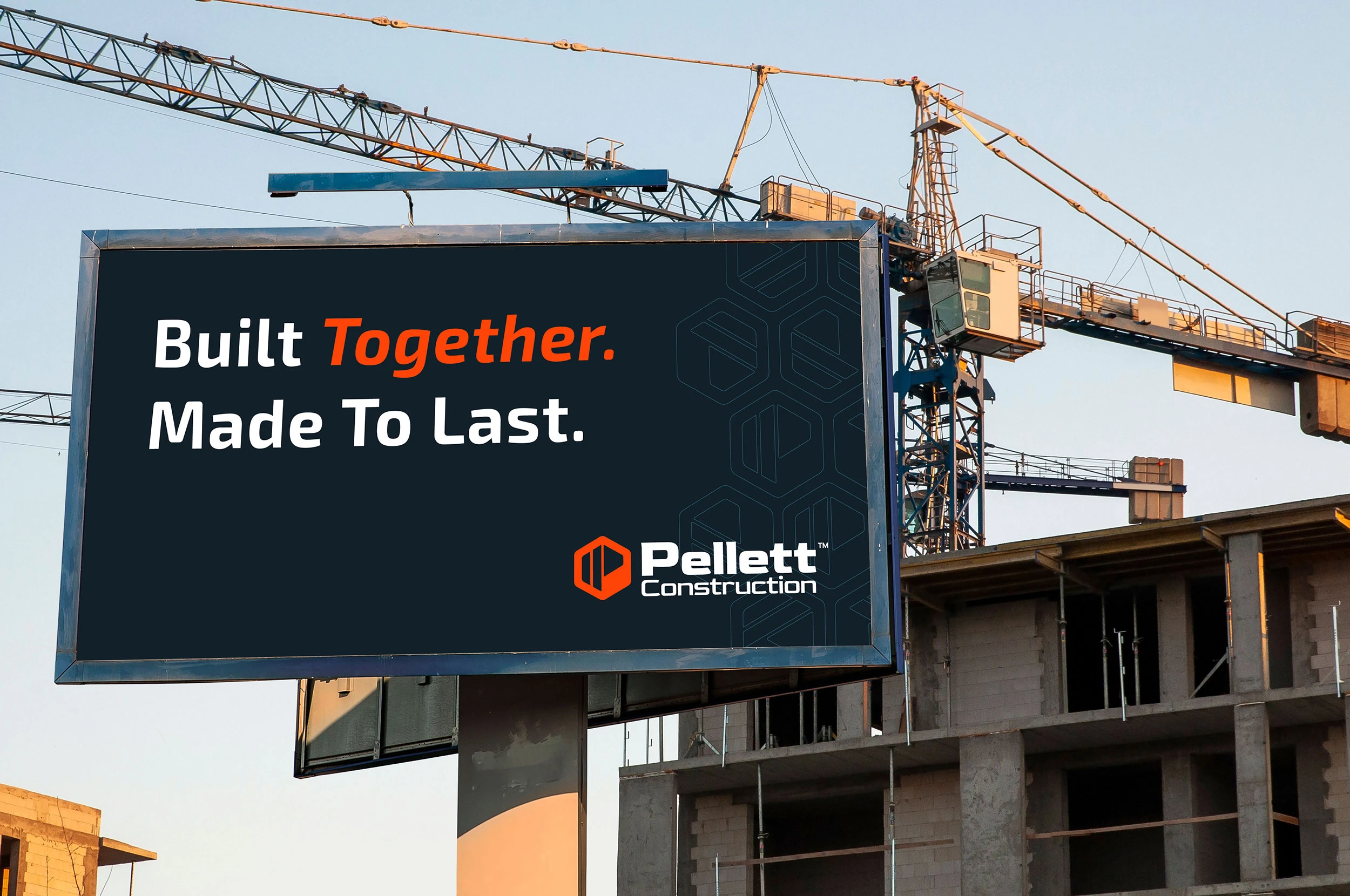 A Pellett Construction billboard at a job site